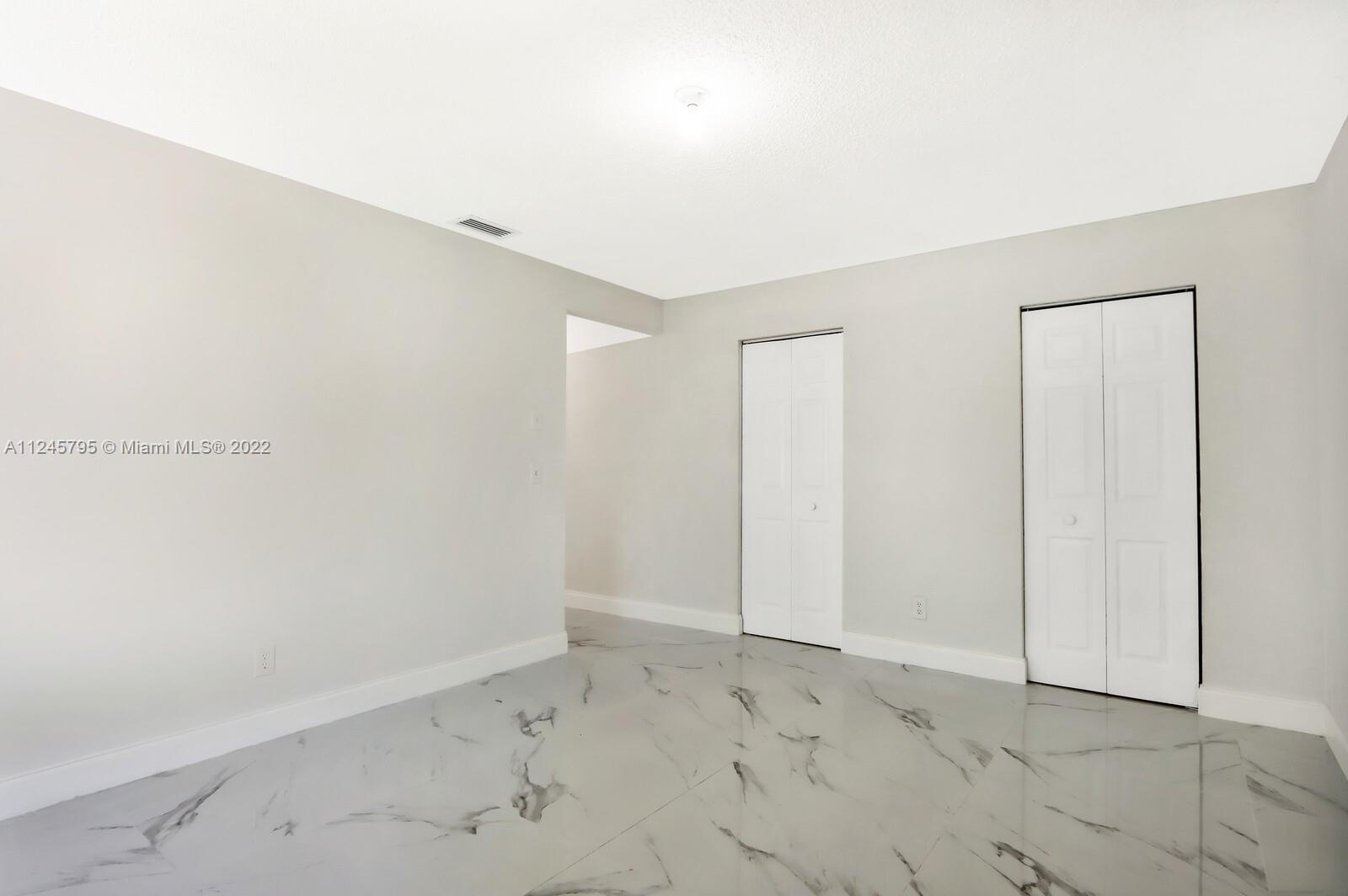 112 Raintree Trail Jupiter, FL 33458 - Photo 30 of 37 an empty room with a hallway