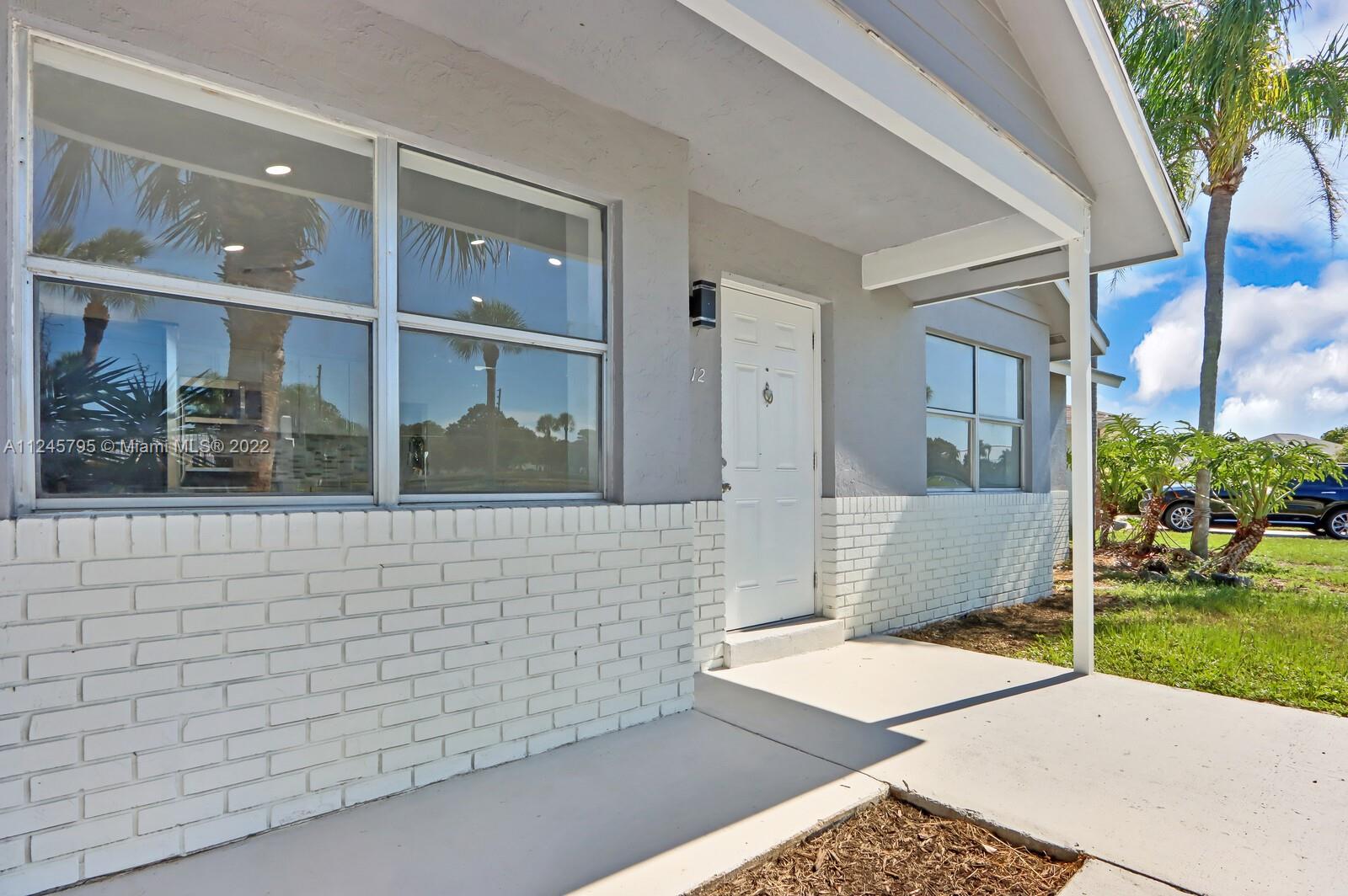 112 Raintree Trail Jupiter, FL 33458 - Photo 3 of 37 a view of entrance gate of the house