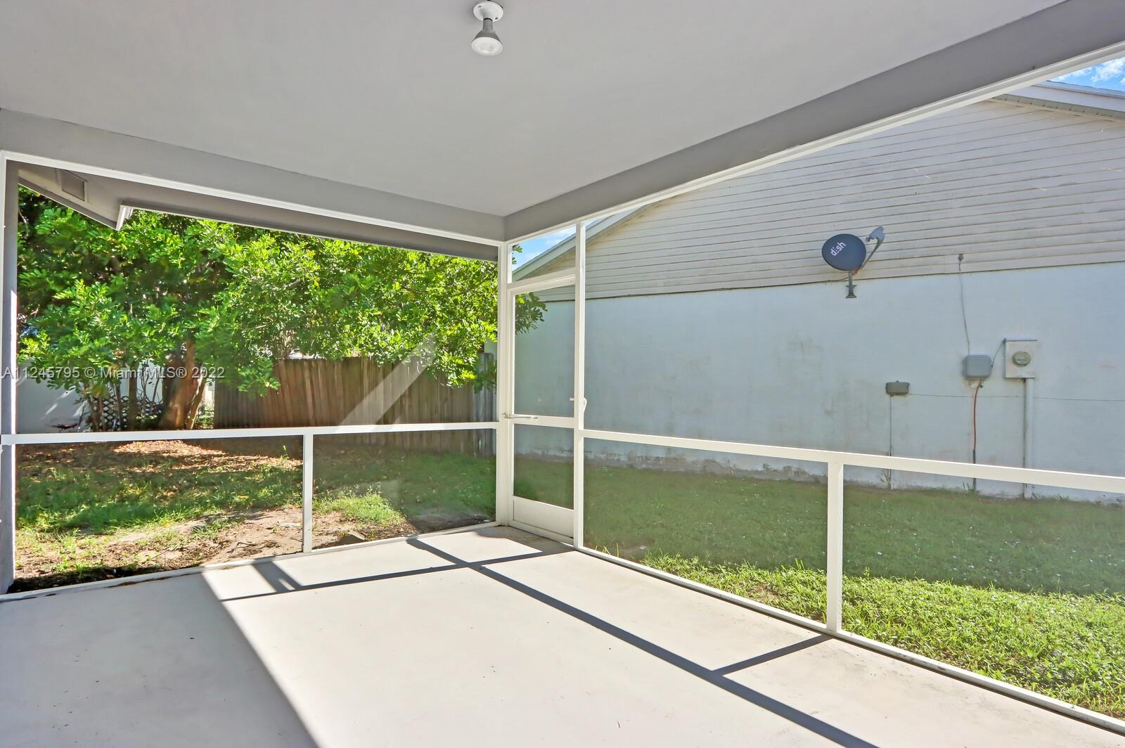 112 Raintree Trail Jupiter, FL 33458 - Photo 10 of 37 a view of a balcony with floor to ceiling windows and wooden fence