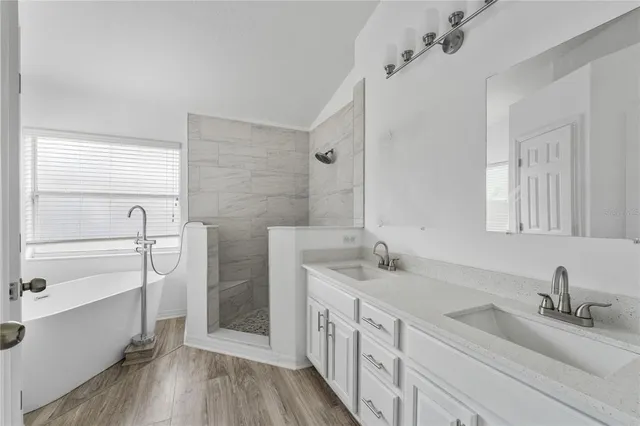 a bathroom with a double vanity sink and mirror