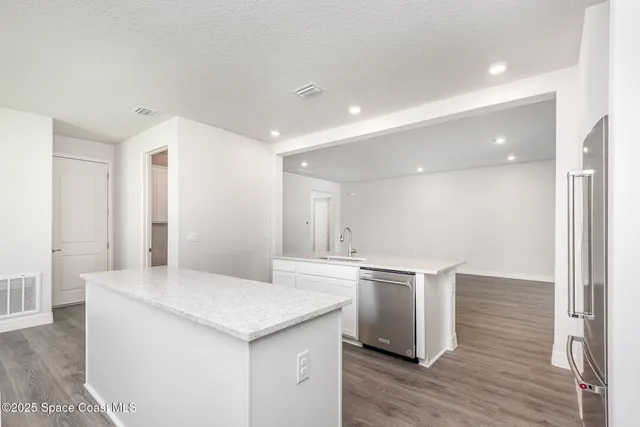 a kitchen with a stove a refrigerator and a sink