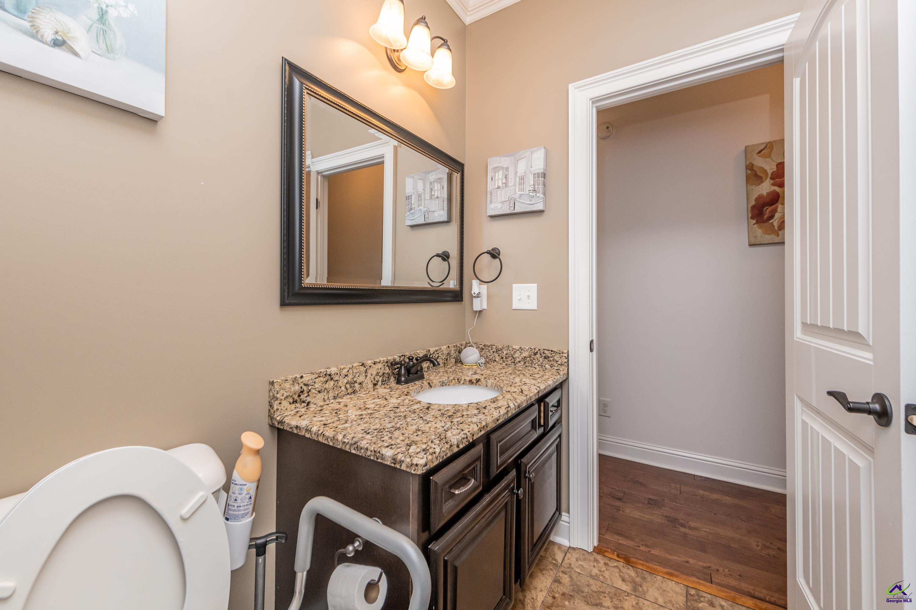405 Old Bridge Road Warner Robins, GA 31088 - Photo 33 of 58 a bathroom with a granite countertop sink and a mirror