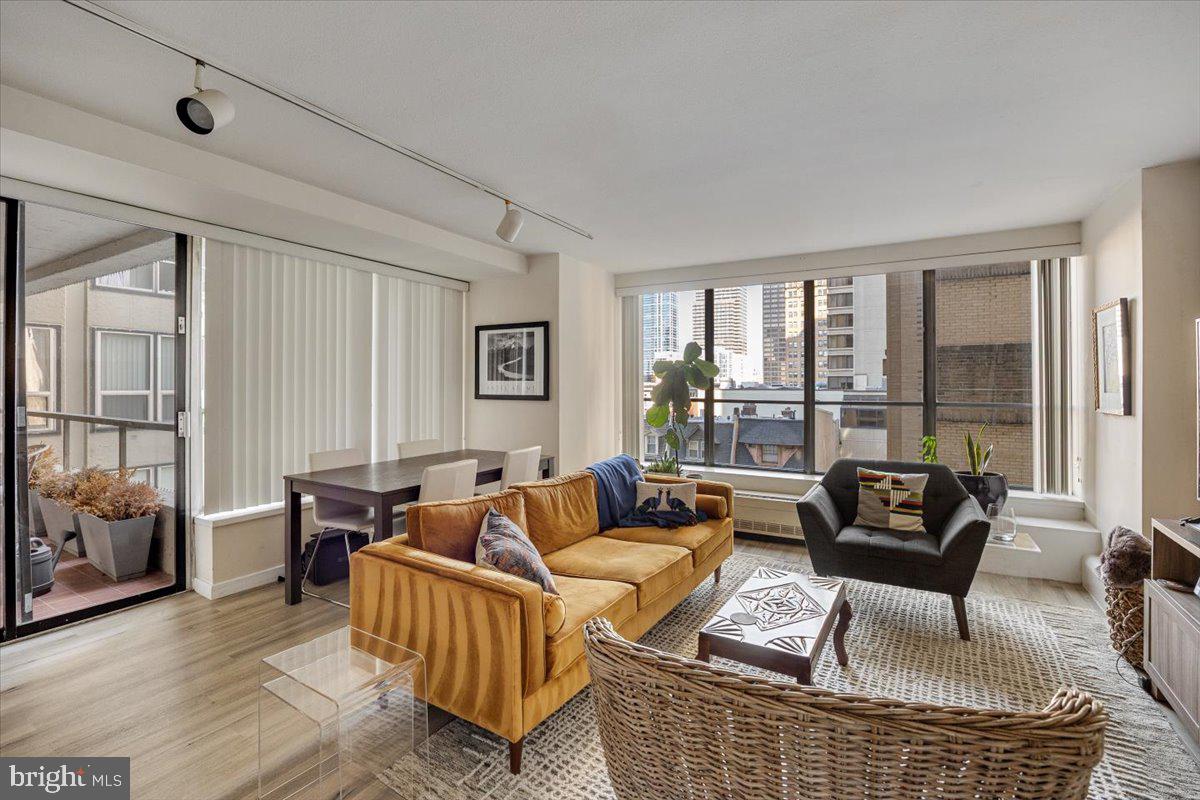 a living room with furniture and floor to ceiling windows