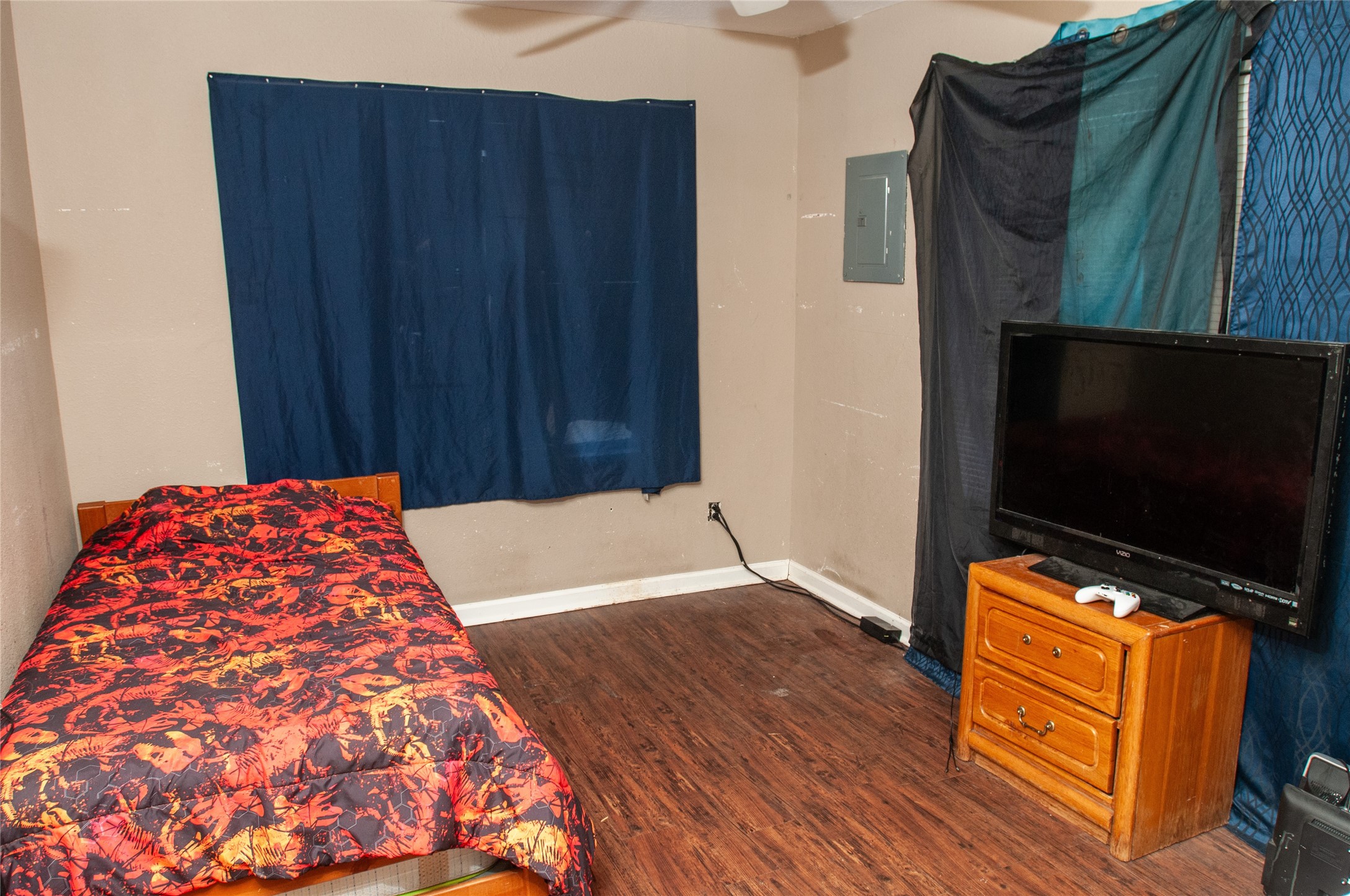 1601 Harris Street Wharton, TX 77488 - Photo 15 of 36 a bedroom with wooden floor table and a flat screen tv
