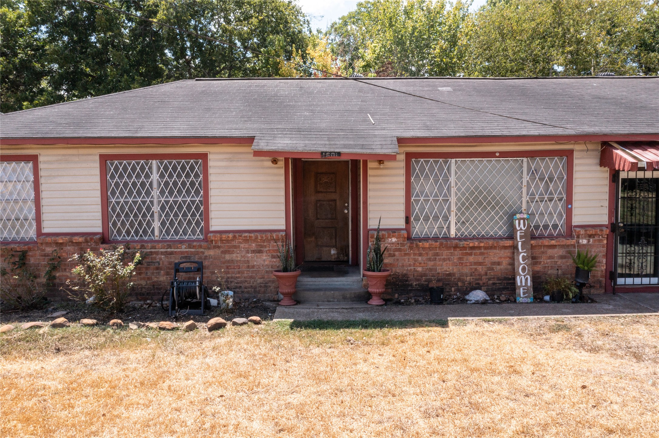 1601 Harris Street Wharton, TX 77488 - Photo 2 of 36 a front view of a house with a yard