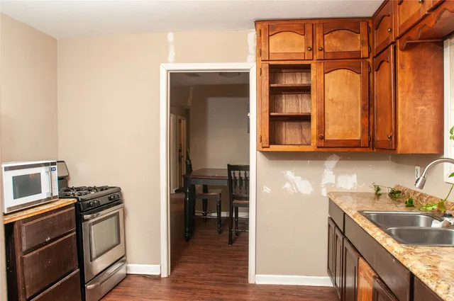 a kitchen with stainless steel appliances granite countertop a stove and a refrigerator
