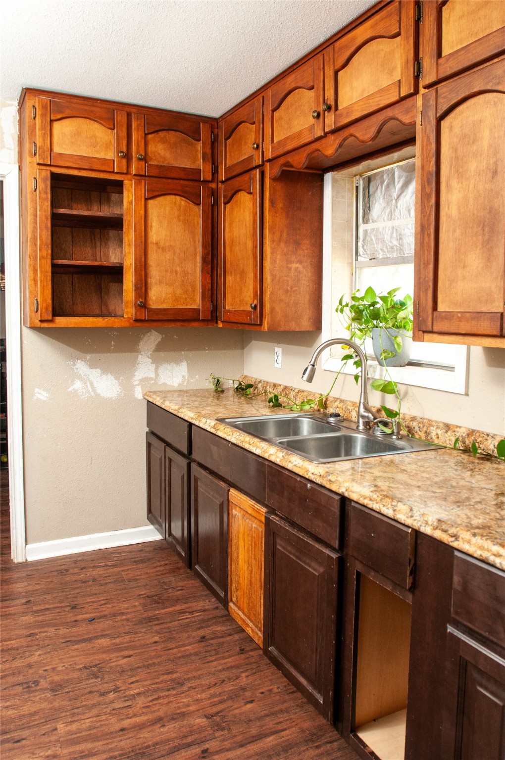 1601 Harris Street Wharton, TX 77488 - Photo 27 of 36 a kitchen with stainless steel appliances kitchen island granite countertop a sink and cabinets