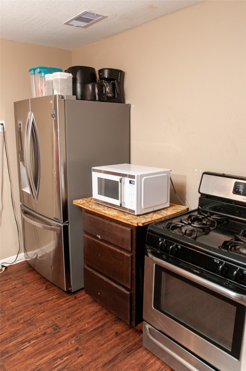 1601 Harris Street Wharton, TX 77488 - Photo 28 of 36 a kitchen with stainless steel appliances granite countertop a stove and a refrigerator