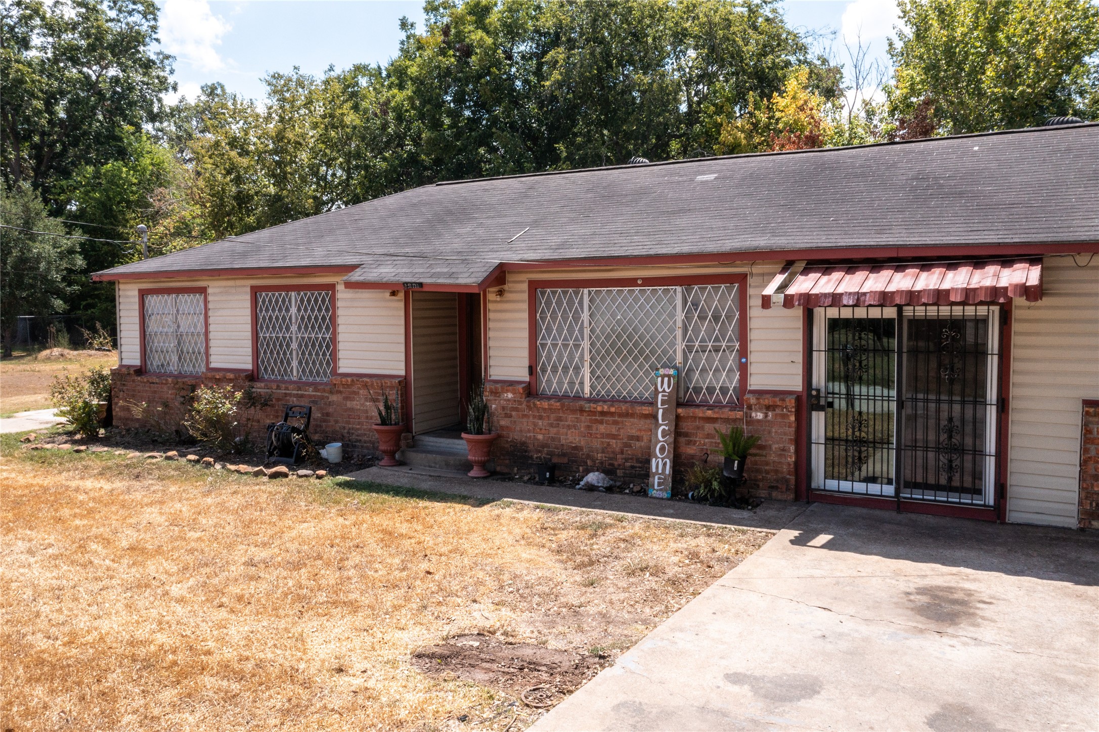 1601 Harris Street Wharton, TX 77488 - Photo 3 of 36 a view of house with yard and trees in the background