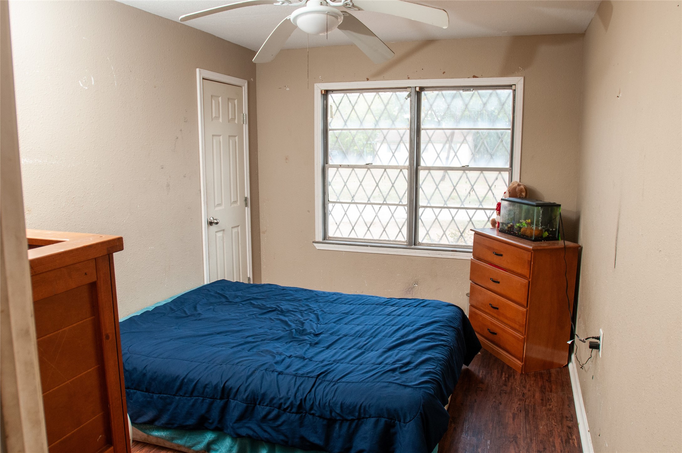 1601 Harris Street Wharton, TX 77488 - Photo 31 of 36 a bedroom with a bed and wooden floor
