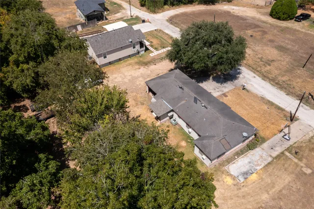 an aerial view of a house with a yard