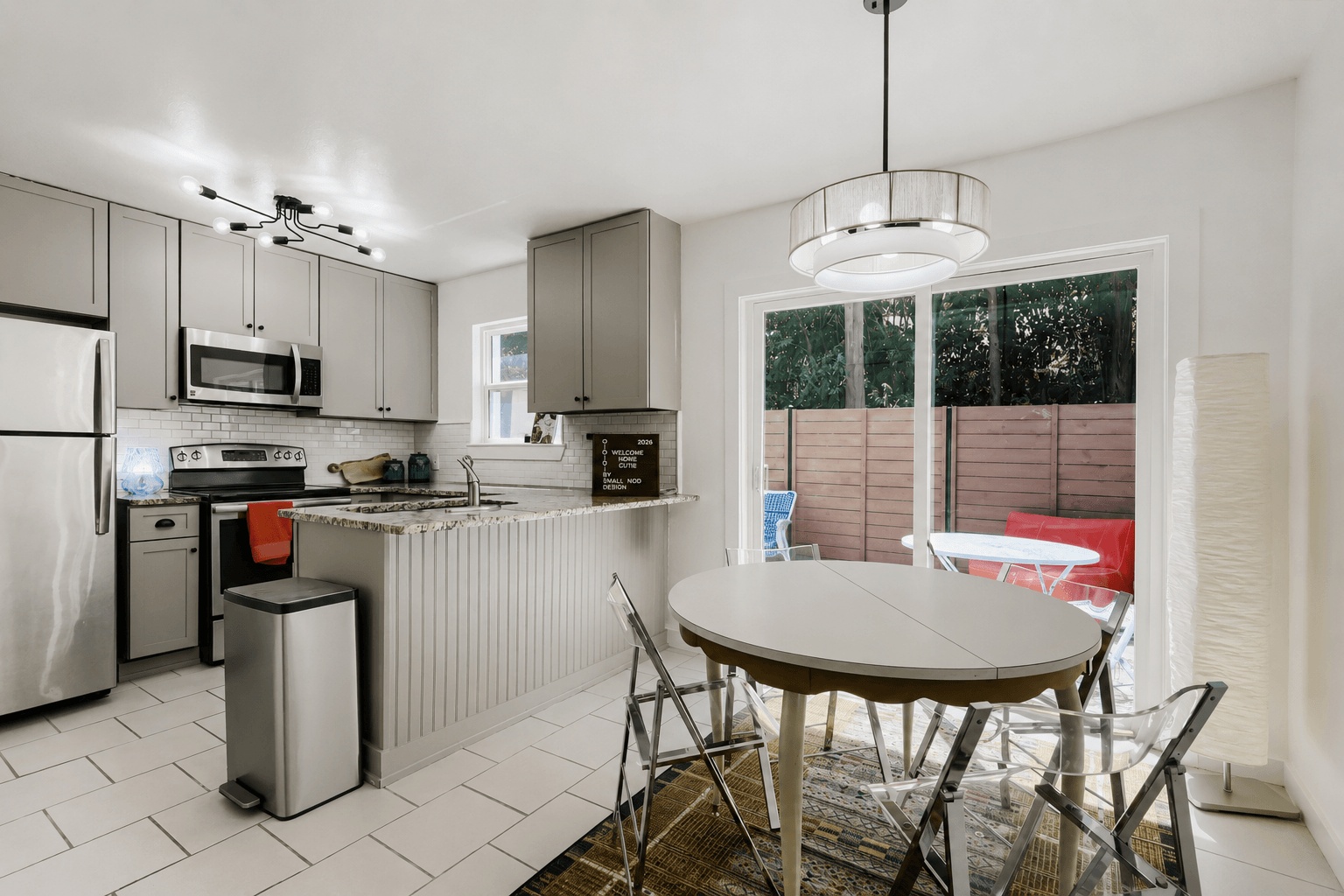 6211 Manor Road, Unit 105 Austin, TX 78723 - Photo 7 of 18 A well-appointed kitchen and dining area features granite countertops and sliding glass doors leading to a private outdoor space.