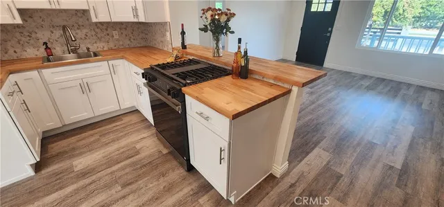 a kitchen with a stove and white cabinets