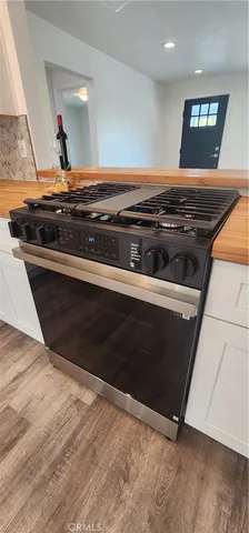a stove top oven sitting inside of a kitchen