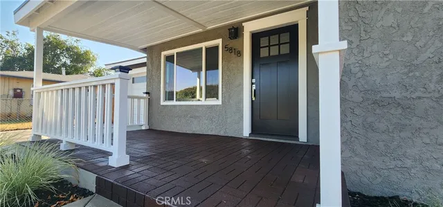 an entryway with wooden floor and fence