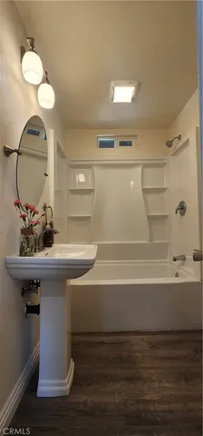 a bathroom with a sink a mirror and a bathtub