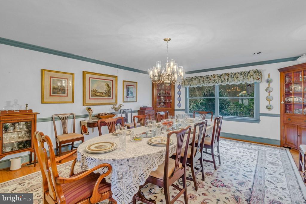 405 Courtney Lane Callao, VA 22435 - Photo 19 of 60 a view of a dining room with furniture a chandelier and wooden floor