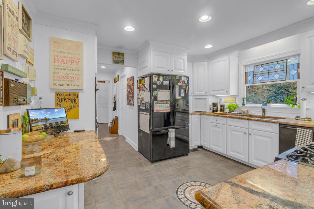 405 Courtney Lane Callao, VA 22435 - Photo 22 of 60 a kitchen with stainless steel appliances granite countertop a refrigerator and a sink