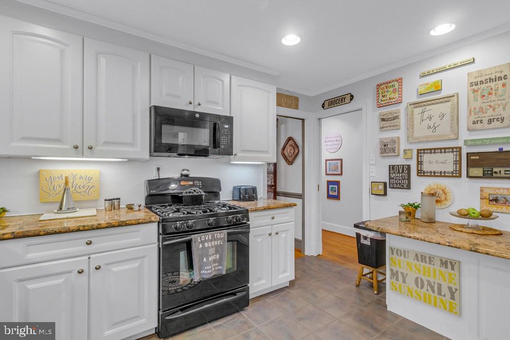 405 Courtney Lane Callao, VA 22435 - Photo 24 of 60 a kitchen with stainless steel appliances a stove a sink and a microwave