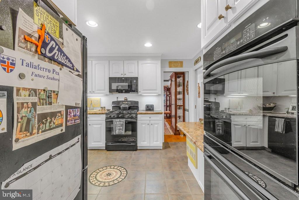405 Courtney Lane Callao, VA 22435 - Photo 25 of 60 a large kitchen with stainless steel appliances granite countertop a stove a sink dishwasher and a refrigerator