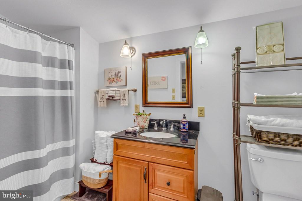 405 Courtney Lane Callao, VA 22435 - Photo 29 of 60 a bathroom with a granite countertop sink and a mirror