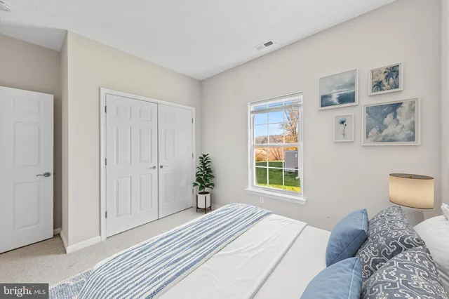 a bedroom with a large bed and a window