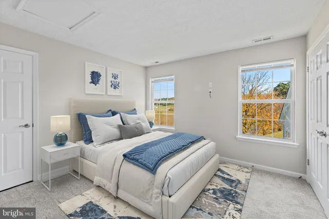 an empty room with windows and closet