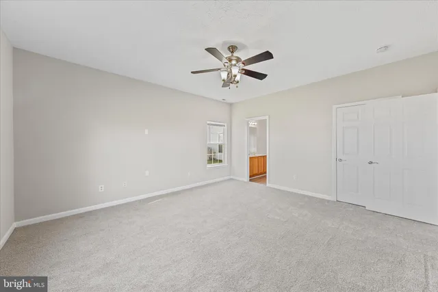 a view of a lake with a big yard and large tree