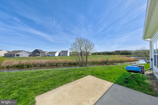 a view of swimming pool with outdoor seating and plants