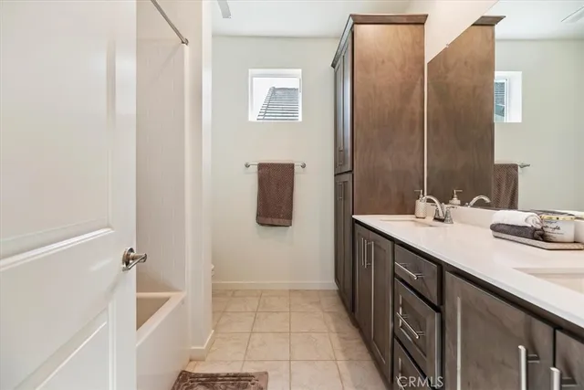 a view of a street with a bench and trees