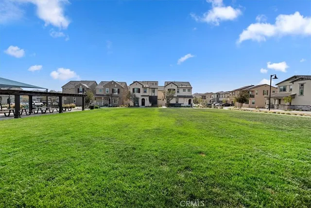 a living room with lots of furniture and kitchen view
