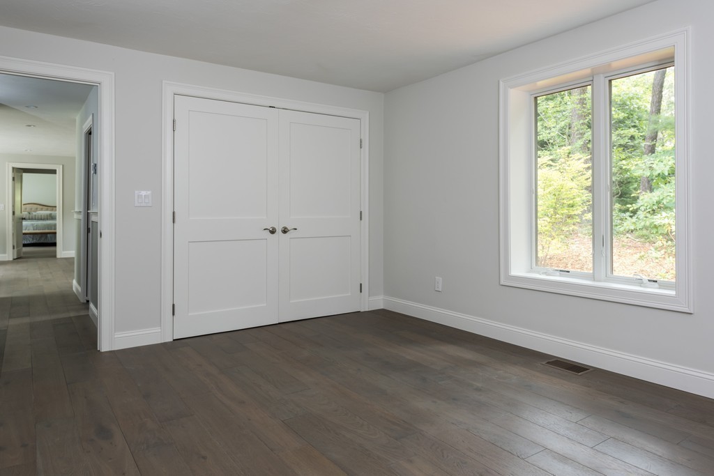 148 Paddock Circle Mashpee, MA 02649 - Photo 16 of 28 an empty room with wooden floor and windows