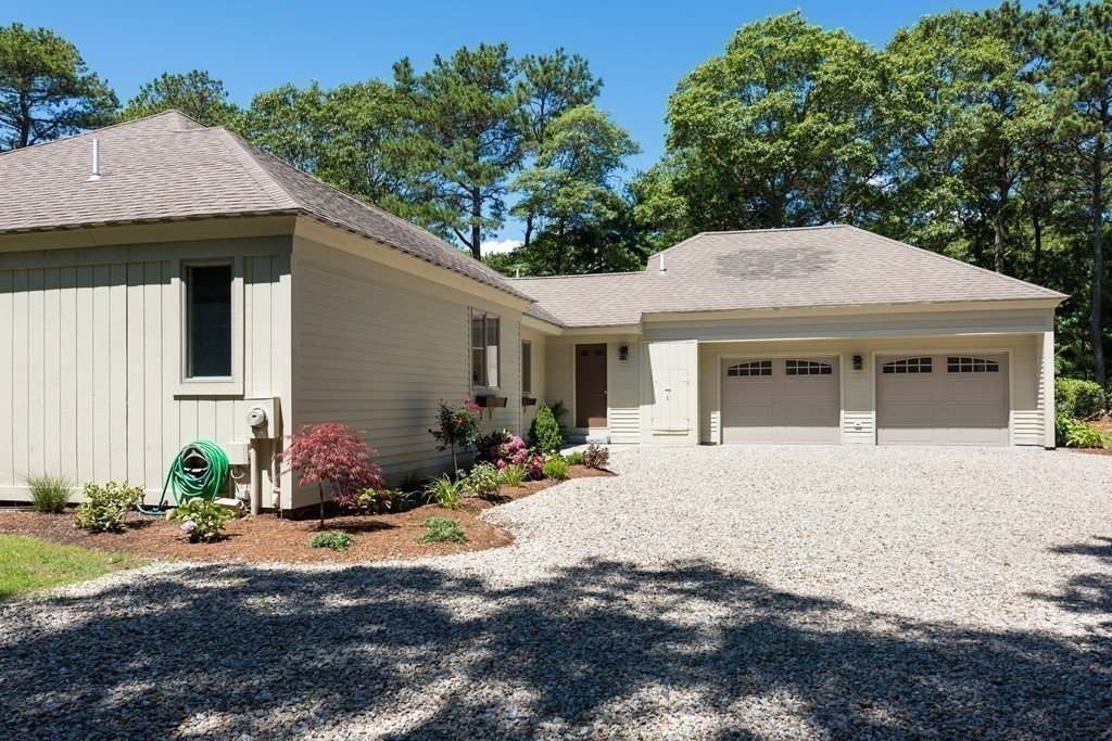148 Paddock Circle Mashpee, MA 02649 - Photo 21 of 28 a front view of a house with a yard and outdoor seating