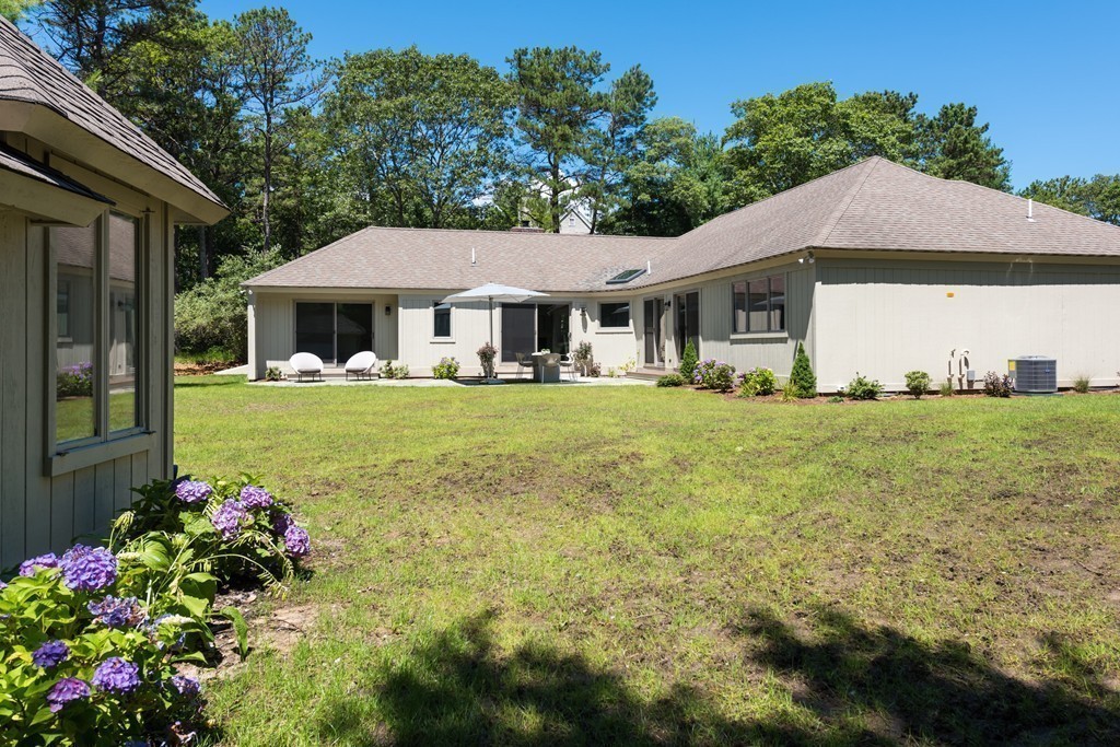 148 Paddock Circle Mashpee, MA 02649 - Photo 23 of 28 a front view of a house with a yard