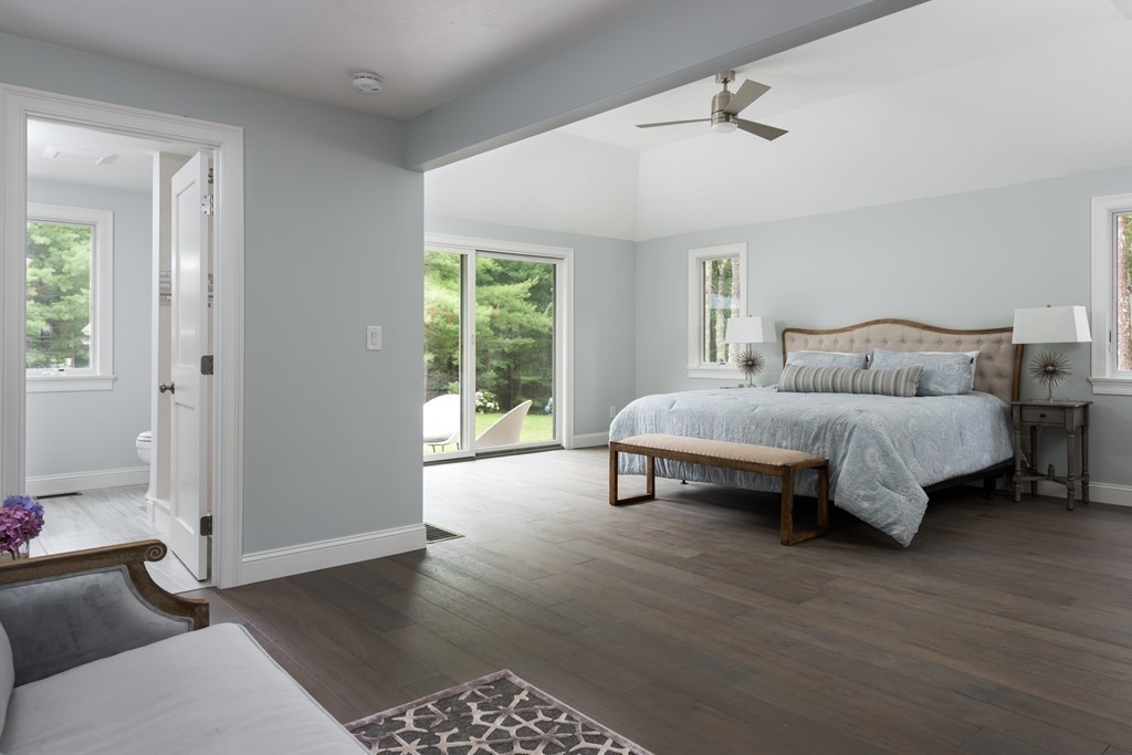 148 Paddock Circle Mashpee, MA 02649 - Photo 8 of 28 a spacious bedroom with a bed and wooden floor