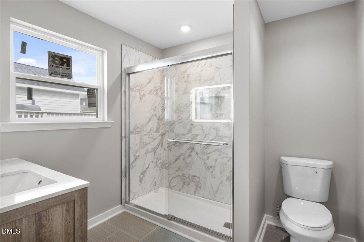 509 Sparella Street Durham, NC 27703 - Photo 23 of 30 a bathroom with a shower a toilet and a sink