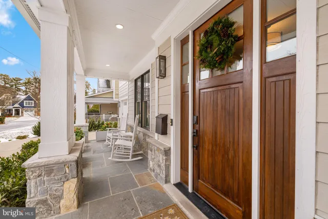 a living room with furniture large window and wooden floor