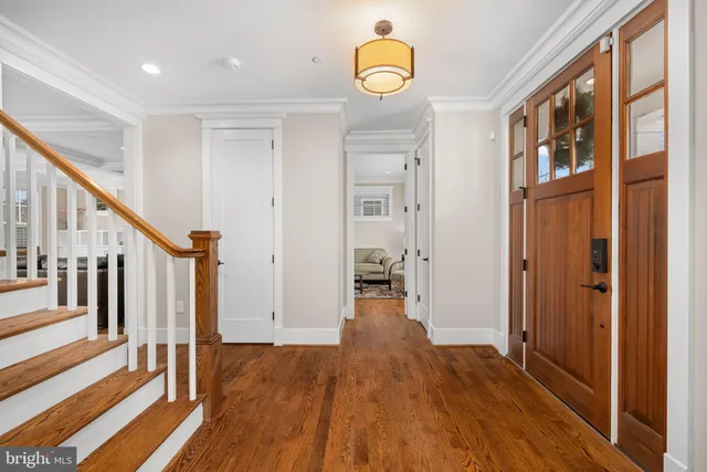 a view of an entryway with wooden floor and stairs