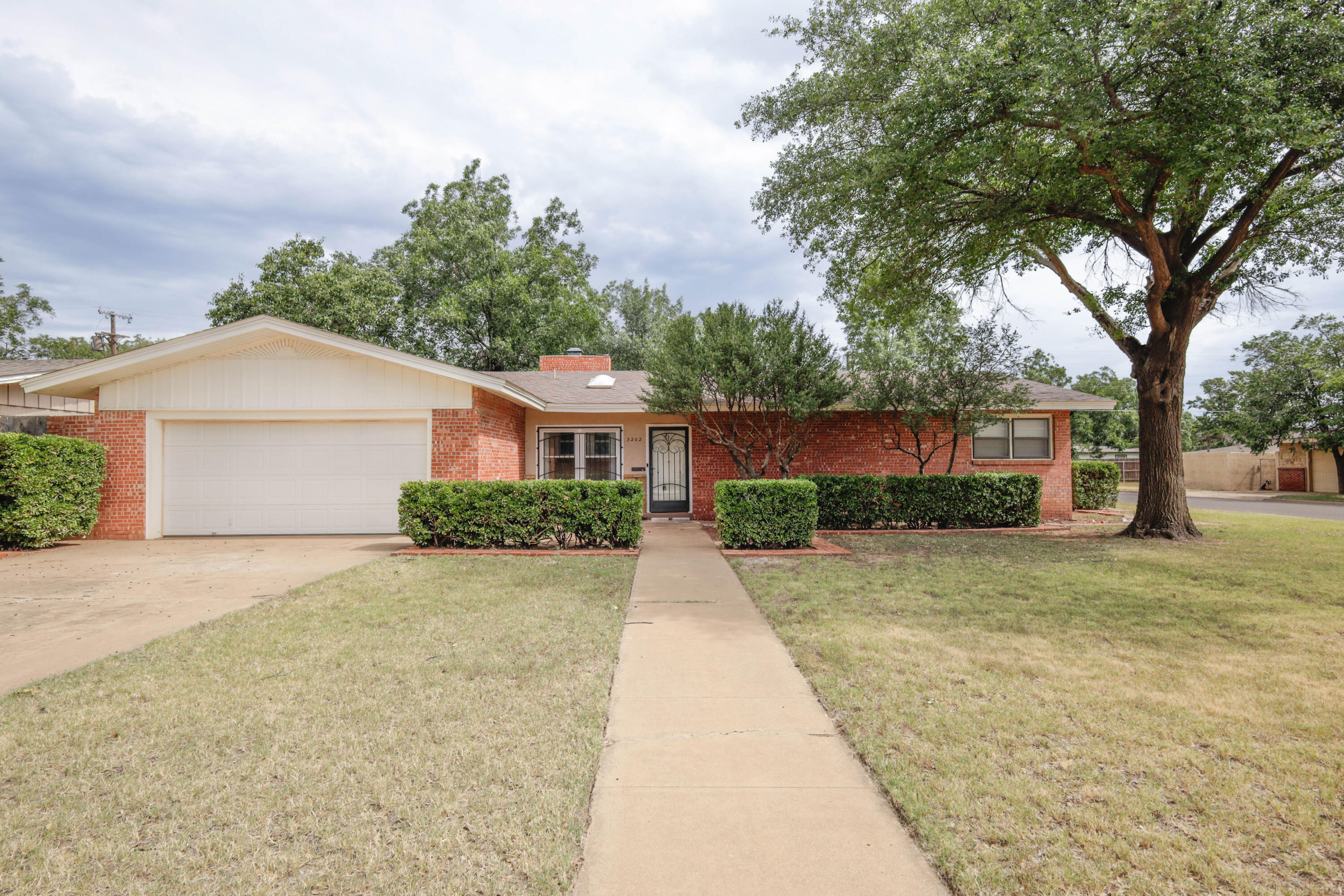 3202 45th Street Lubbock, TX 79413 - Photo 1 of 20 front view of a house with a yard