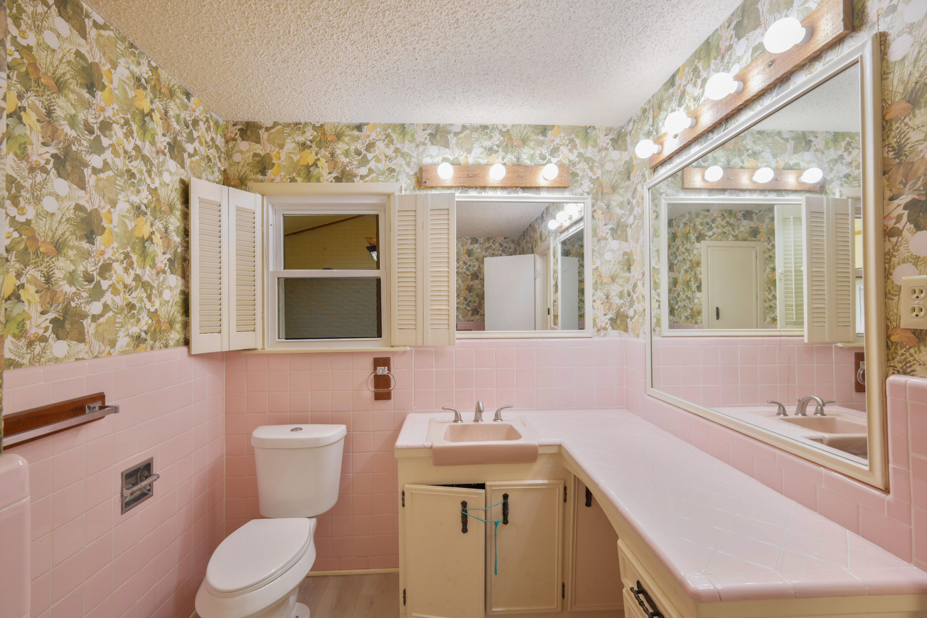3202 45th Street Lubbock, TX 79413 - Photo 12 of 20 a bathroom with a sink a toilet and mirror