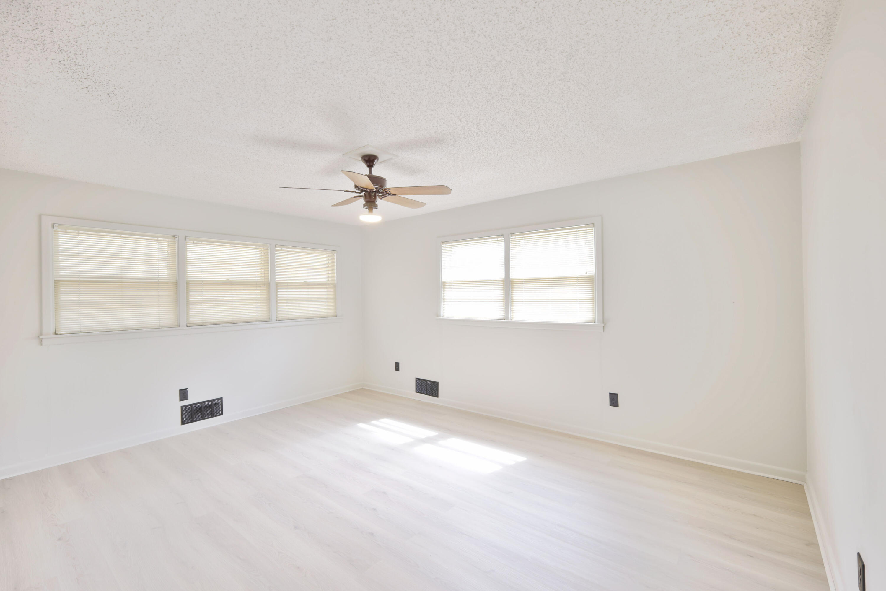 3202 45th Street Lubbock, TX 79413 - Photo 15 of 20 an empty room with windows and chandelier fan