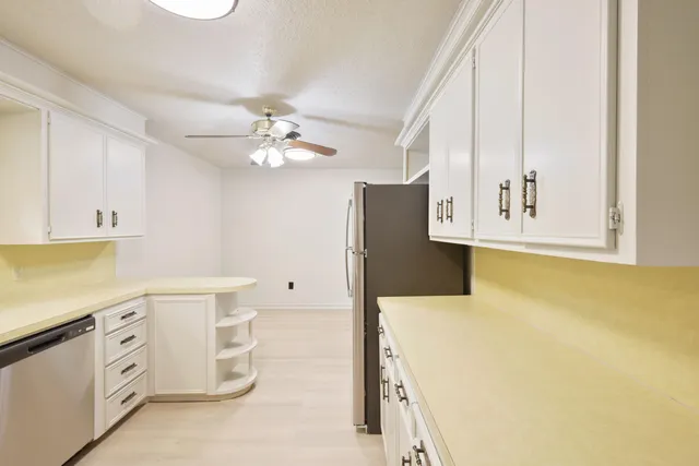 a kitchen with stainless steel appliances a white cabinets and sink