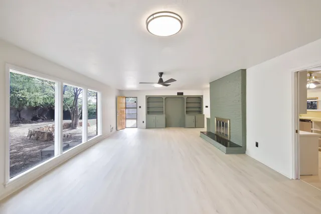 a view of a kitchen with a sink and a large window