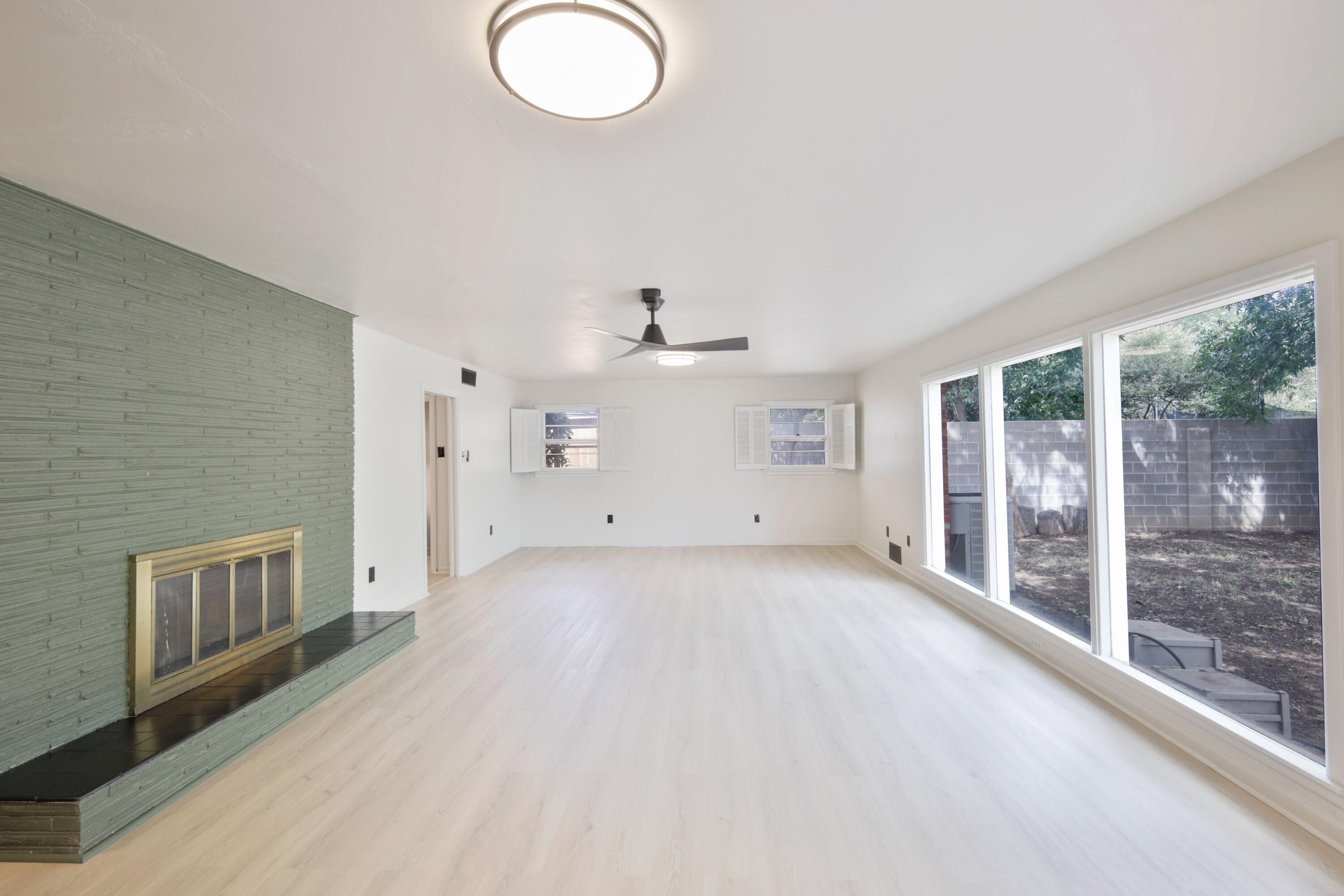 3202 45th Street Lubbock, TX 79413 - Photo 10 of 20 a view of a livingroom with wooden floor and a large window