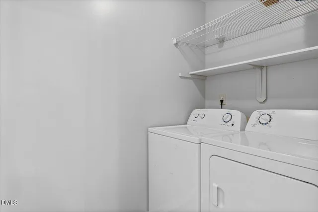 an empty room with windows and chandelier fan