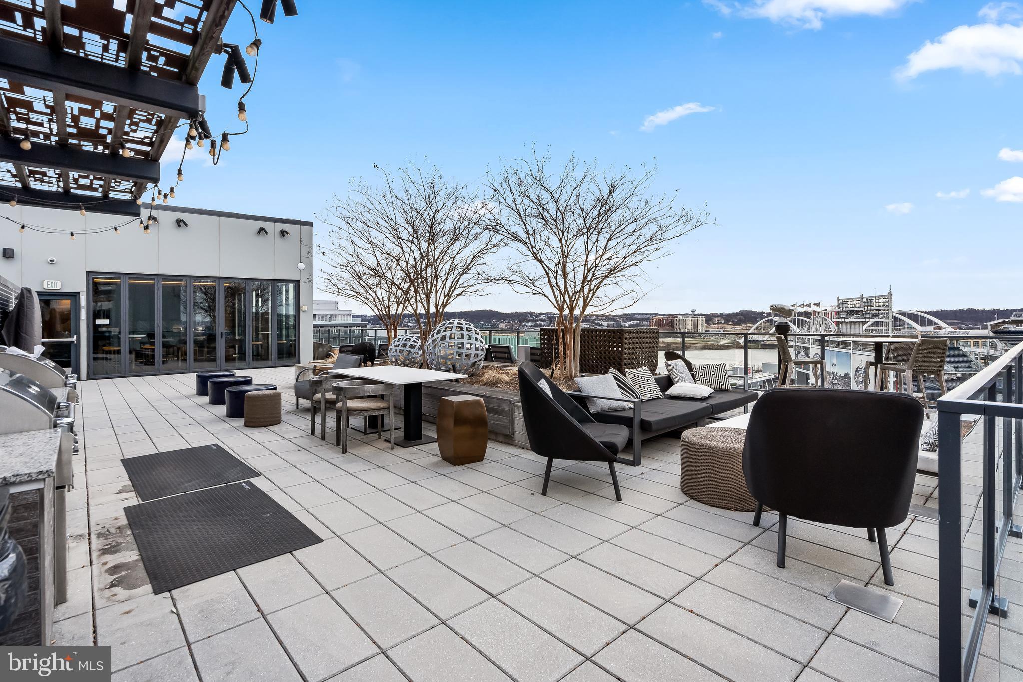 70 N Street Southeast, Unit N815 Washington, DC 20003 - Photo 17 of 27 a roof deck with table and chairs