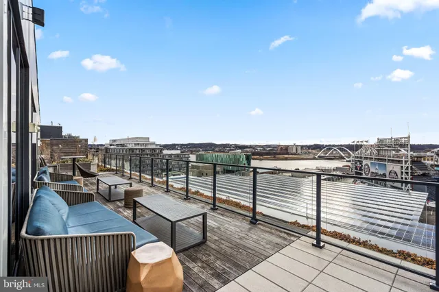 a terrace with outdoor seating and city view