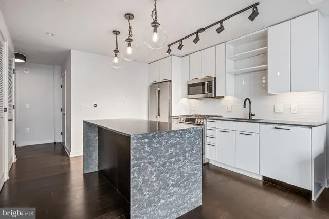 a kitchen with a sink stove and refrigerator