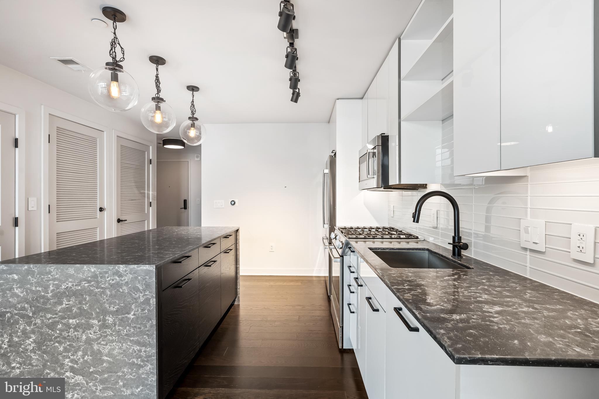 70 N Street Southeast, Unit N815 Washington, DC 20003 - Photo 5 of 27 a kitchen with stainless steel appliances granite countertop a sink a stove and a refrigerator