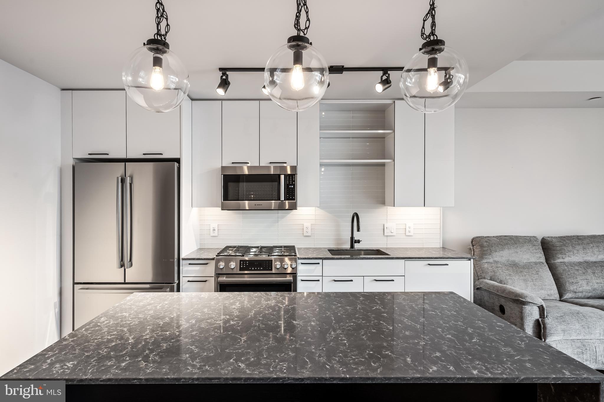 70 N Street Southeast, Unit N815 Washington, DC 20003 - Photo 7 of 27 a kitchen with cabinets and stainless steel appliances